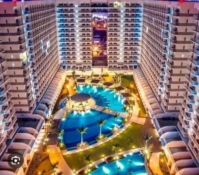 an aerial view of a large building with a pool at Xenial Pasay City Apartment for Rent - Entire House Front of Mall of Asia in Manila