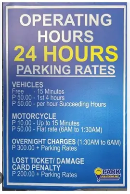 a sign that says operating hours and hours parking rates at Dainty Pasay City Apartment for Rent - Entire House Front of Mall of Asia in Manila
