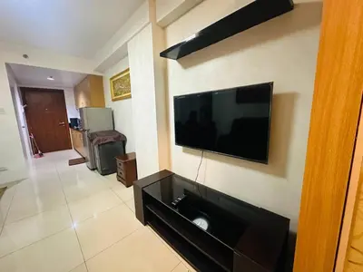 a living room with a flat screen tv on the wall at Dainty Pasay City Apartment for Rent - Entire House Front of Mall of Asia in Manila