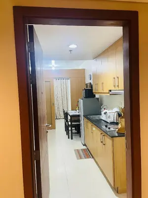 a kitchen with a table and a dining room at Fancy Pasay City Apartment for Rent - Mall of Asia Nearby front of Mall Of Asia in Manila