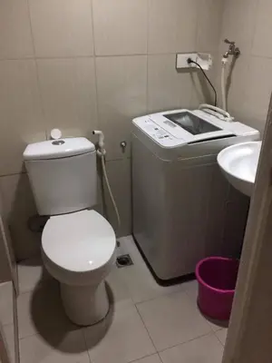 a small bathroom with a toilet and a sink at Joyful Pasay Getaway Staycation Condo Near MOA and IKEA near Mall of Asia in Manila