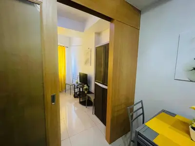 a door leading into a dining room with a table at Joyful Pasay Getaway Staycation Condo Near MOA and IKEA near Mall of Asia in Manila