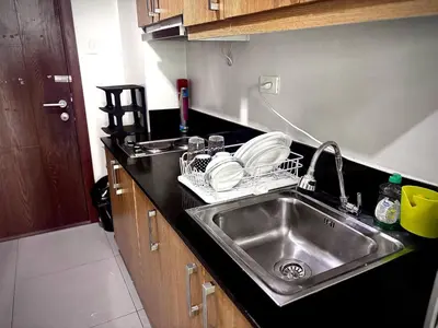 a kitchen sink with dishes in a kitchen at Kempt Pasay City Apartment for Rent - Perfect for Short-Term Stay front of MOA in Manila