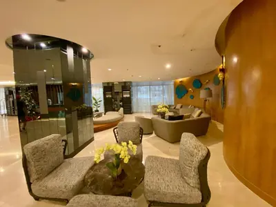 a living room with two chairs and a couch at Cordial Condo in Manila
