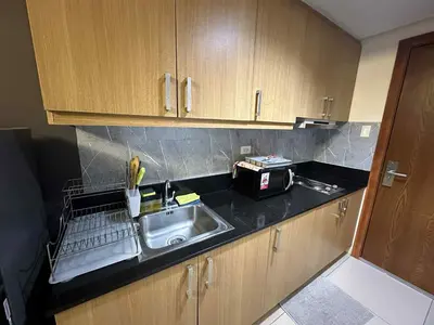 a kitchen with a sink and a counter top at Shell Residence Pasay MOA with 2 Beds by G&K in Manila