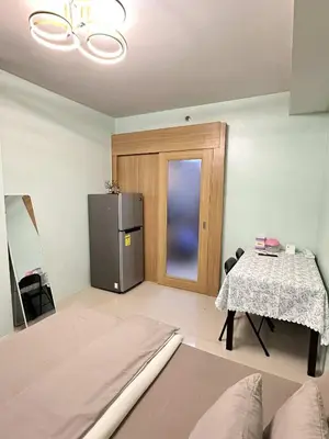 a living room with a refrigerator and a table at Shell Residence Pasay MOA with 2 Beds by G&K in Manila
