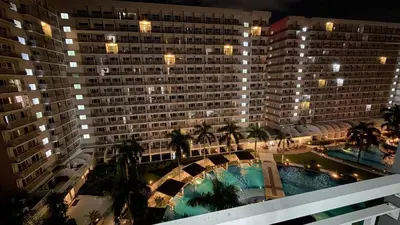 an overhead view of a large building with a swimming pool at Staycapades at Shell Residences in Manila