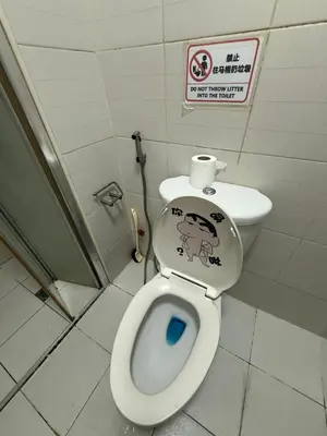 a bathroom with a toilet with a sticker on the seat at 2 Bedroom staycation at Jazz Residences Makati and Paid Private Parking in Manila