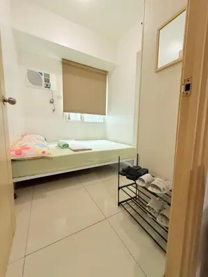 a small room with a bed and a window at 2 Bedroom staycation at Jazz Residences Makati and Paid Private Parking in Manila