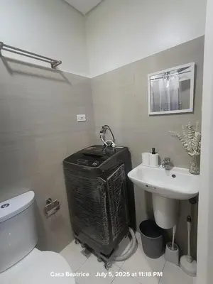 a bathroom with a toilet and a sink at Cozy 19 at Shore 2 Residences in Manila