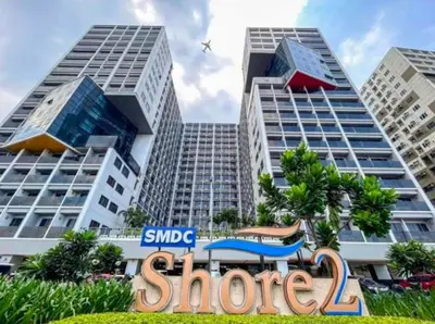 a sign in front of two tall buildings at shore 2 residences admin in Manila
