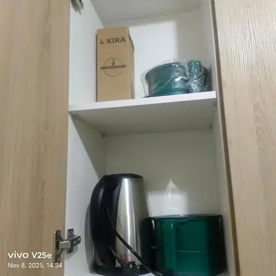 a cupboard with a kettle and a box on a shelf at shore 2 residences admin in Manila
