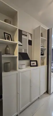 a white kitchen with white cabinets and shelves at Homey Roxas Blvd Condo Pool Parking WiFi in Manila