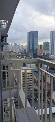 a view of a city from the balcony of a building at Gavinne Place Coast Residences in Manila