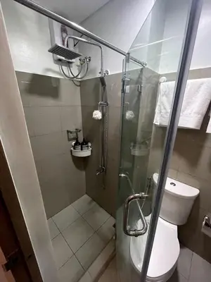 a bathroom with a shower and a toilet at Perfect Sunset View in Pasay Near MOA & NAIA in Manila