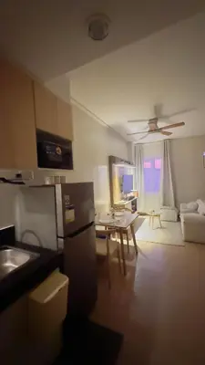a kitchen and living room with a couch and a table at Resort Condo in Trece Martires Cavite in Trece Martires