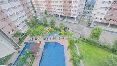 an overhead view of a swimming pool with palm trees at Resort Condo in Trece Martires Cavite in Trece Martires