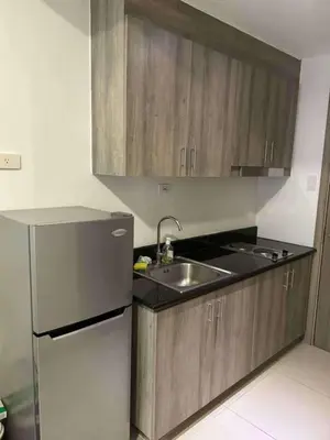 a kitchen with a sink and a refrigerator at Condo unit for rent in Manila