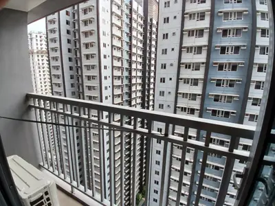 a balcony with a view of tall buildings at Condo unit for rent in Manila