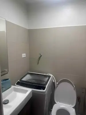 a small bathroom with a sink and a toilet at Staycation in Oasis in Manila