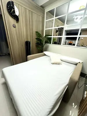 a large white bed in a room with a window at JB Urban Nest at SMDC Fame Residences in Manila