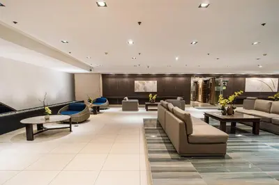 a lobby of a hotel with couches and tables at Relaxing Hotel Apartment Stay : Near MOA & Airport in Manila