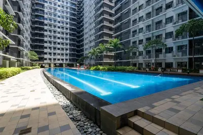 a swimming pool in the middle of a building at Modern Industrial 1 BR | Condo | MOA Shore 3 NAIA in Manila