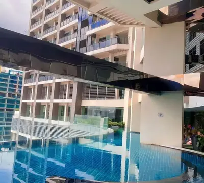 a swimming pool in front of a building at Elegant Stylish 1 Bedroom Balcony City and Manila Bay view FREE Sauna Pool GYM Makati in Manila