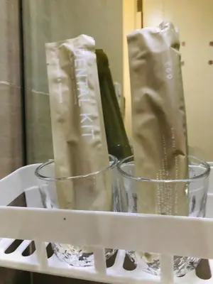 a shelf with two cups and a bottle of wine at Grand view Venice 1BR with balcony near BGC in Manila