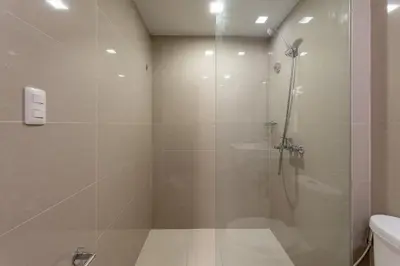 a bathroom with a shower with a glass door at Spacious 3 BR in Uptown Parksuites, BGC Fast Wi Fi Washer in Manila