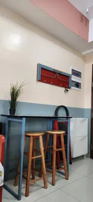 a kitchen with two stools and a counter at 22e BGC Unit 3 mins Walk to The Venice Grand Canal Mall Pet Friendly in Manila