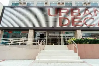 a building with a large sign on the front of it at Urban Deca Tower Jen Nizami in Manila