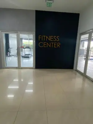 an entrance to a fitness center with two glass doors at EDSA Heights Penthouse unit 3402 AMA Tower Residences in Manila