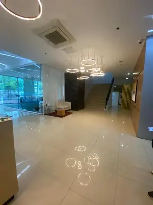 a lobby with a staircase and chandeliers in a building at EDSA Heights Penthouse unit 3402 AMA Tower Residences in Manila