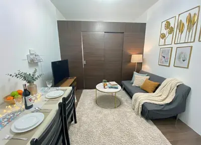 a living room with a couch and a table at Air Residences 46F Stunning View Wifi & Netflix in Manila