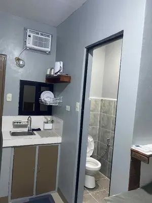 a bathroom with a sink and a toilet at Airport Transient Pasay in Manila