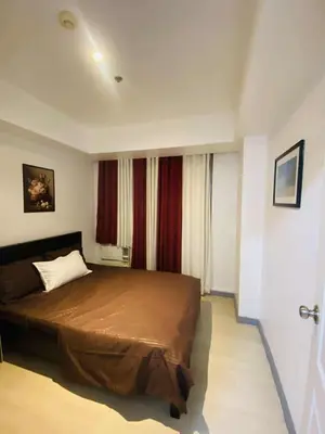 a bedroom with a large bed in a room at Azure Urban Staycation in Manila