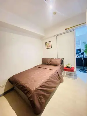 a bedroom with a large bed in a room at Azure Urban Staycation in Manila