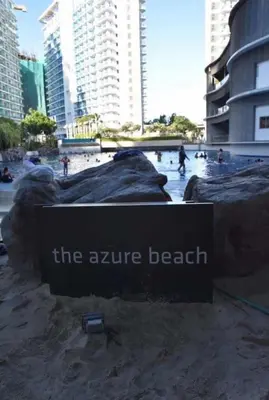 a sign for the arrive beach in a city at Azure Urban Staycation in Manila