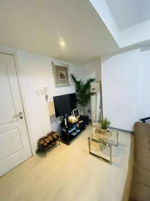 a living room with a couch and a flat screen tv at Azure Urban Staycation in Manila