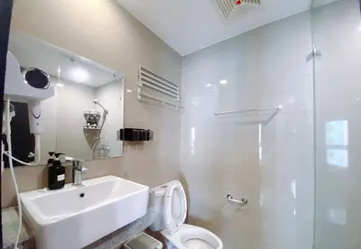 a bathroom with a sink and a toilet and a shower at 120 Sqm Modern 3 Bedrooms HighRise Facing Manila Bay Sunset, Near Manila Airports, Okada Casino, Solaire Casino, MOA with Free Parking in Manila