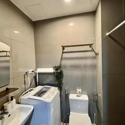 a bathroom with a shower and a toilet and a sink at Air residence city view staycation in Manila