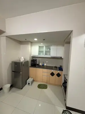 a kitchen with a sink and a refrigerator at 101 Newport Boulevard Pasay City Condotel in Manila