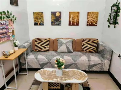 a living room with a couch and a table at Staycation at Brgy Cupang in Manila