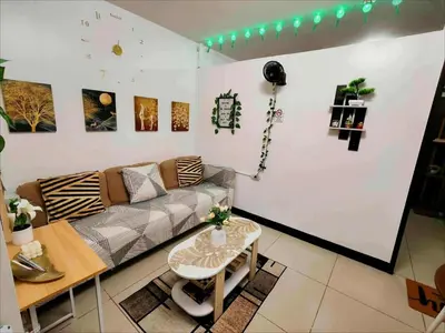 a living room with a couch and a table at Staycation at Brgy Cupang in Manila