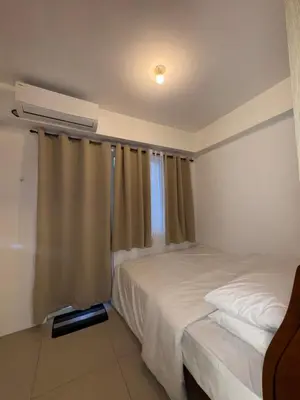 a bedroom with two beds and a window at The Chill Lane- Shore Residences in Manila
