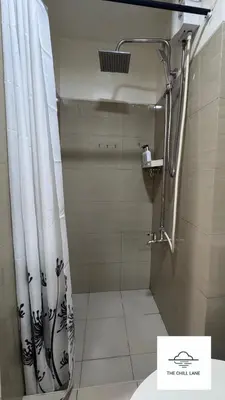 a bathroom with a shower with a shower curtain at The Chill Lane- Shore Residences in Manila