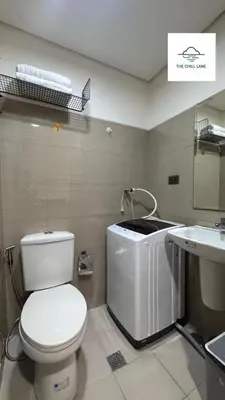 a bathroom with a toilet and a sink at The Chill Lane- Shore Residences in Manila