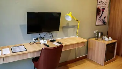 an office with a desk with a computer and a lamp at Madison 101 Hotel + Tower in Manila