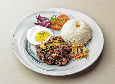 a plate of food with a boiled egg and rice at Madison 101 Hotel + Tower in Manila
